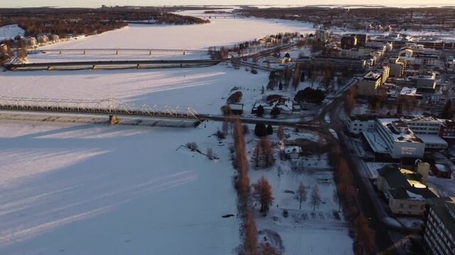 Bridges over frozen and snowy Torne River, Tornio City in winter, Finland. Aerial