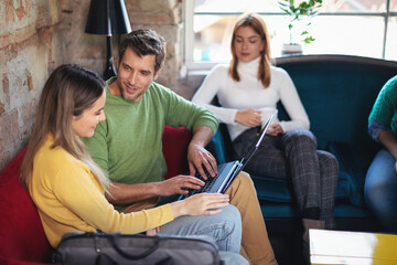 Young software developers in coworking open space taking a break