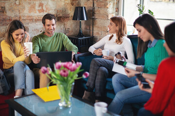 Young software developers in coworking open space taking a break