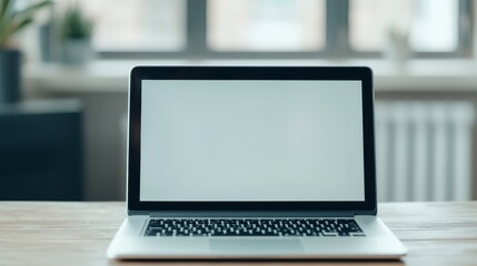 Laptop on a wooden desk with a blank screen in a bright room. Virtual teams with communication concept.