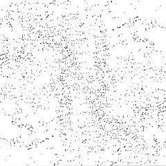 Obraz premium A dense scattering of small dark dots covers a predominantly white background.