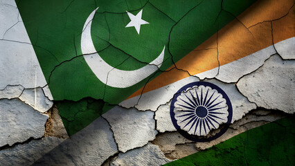 Concept of a Conflict between India and Pakistan with painted flags on a wall with a crack