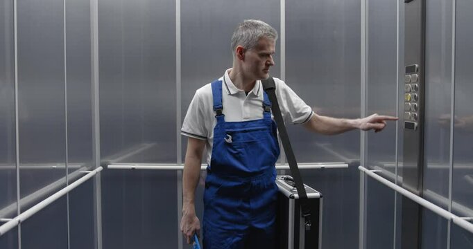 Professional plumber taking the elevator