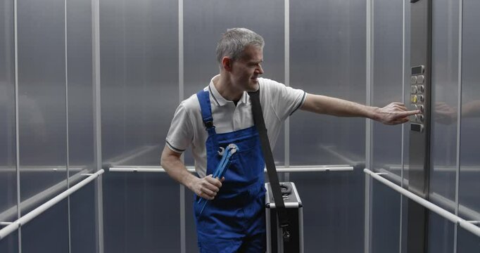 Cheerful plumber dancing and singing in the elevator