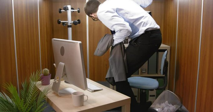 Funny clumsy employee in a small office