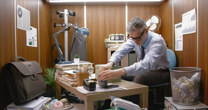 Office worker using objects as drums