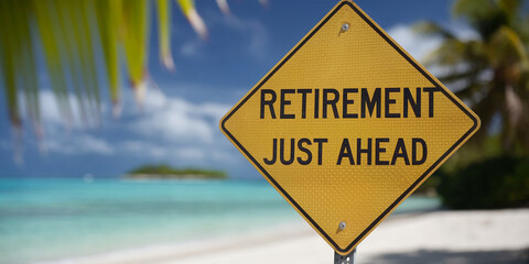 Yellow diamond road sign, reads "Retirement Just Ahead," beach background, symbolizes approaching retirement and relaxation