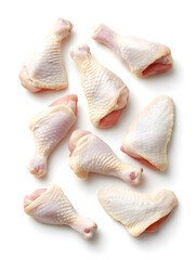 Raw chicken legs and wings on a white background