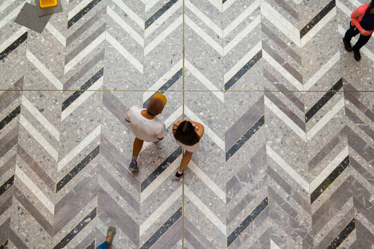 People seen from above walking in a shopping mall