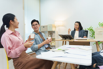 Team members conduct a collaborative meeting in a bright office space while discussing innovative project ideas and sharing feedback