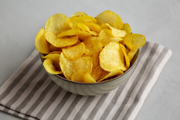 Homemade Kettle Cooked Potato Chips with Salt in a Bowl, side view.