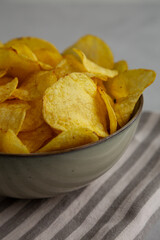 Homemade Kettle Cooked Potato Chips with Salt in a Bowl, side view.