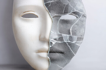 A cracked mirror reflects a half-white, half-black mask, symbolizing duality and inner conflict with clear details and texture highlighted in the design