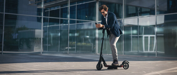 Businessman on e scooter in the city