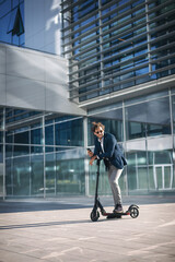 Businessman on e scooter in the city