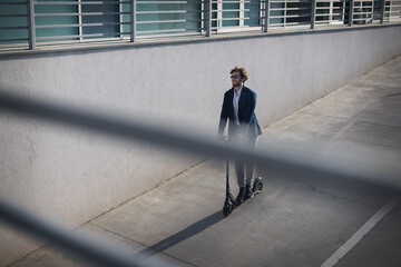 Businessman on e scooter in the city