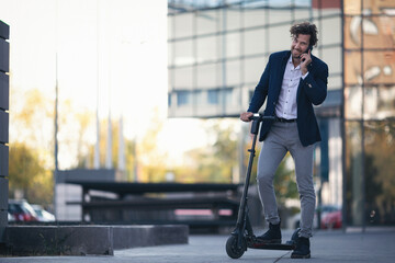 Businessman on e scooter in the city