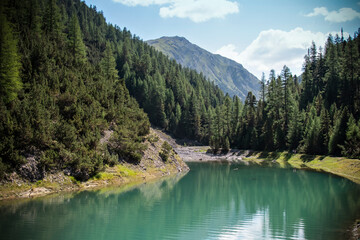Scenic mountain lake with reflections and pine forest