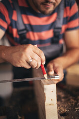 Young carpenter glueing wood