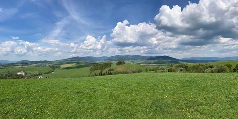 Aerial view of the Czech landscape with mountains and forests at sunset. Scenic spring evening over the Orlicke Mountains,, and Dolni Morava region