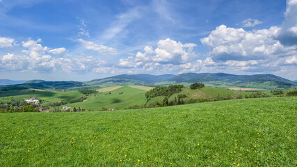 Naklejka premium Aerial view of the Czech landscape with mountains and forests at sunset. Scenic spring evening over the Orlicke Mountains,, and Dolni Morava region