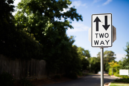 Street sign directing traffic two ways