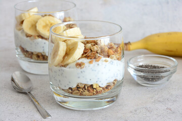 a glass of Yogurt with Banana, Granola and Chia Seeds