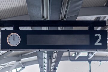 LED panel display with analog clock in the train station. Train Schedule Display.