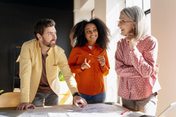 Architects discussing blueprints in the office