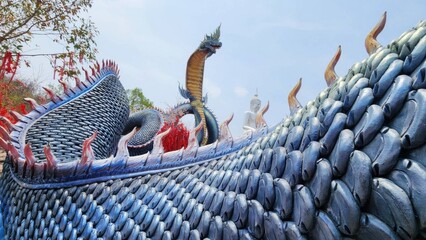 Majestic Dragon Sculpture on Temple Roof in Clear Blue Sky