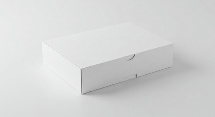 Empty white cardboard box on a plain light gray surface. Product packaging mockup for graphic design inspiration.