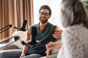 Two podcasters recording a new episode in home studio