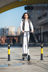 Young businesswoman on e scooter in the city