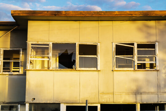 Broken windows in a derelict house