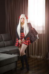 Bad sexy student girl in a short skirt and stockings loves to admire herself.