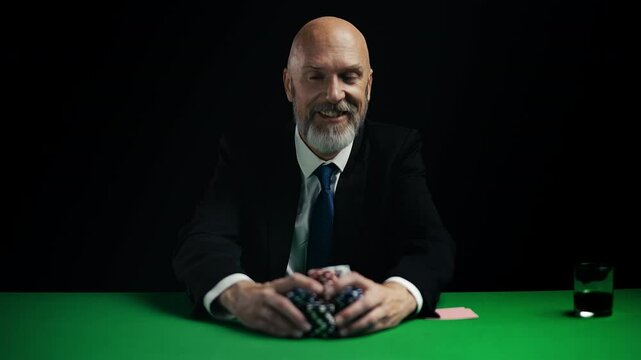Happy businessman risking all his money on poker game, raising final bet