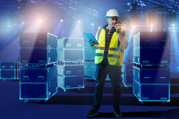 Event production supervisor in safety gear manages equipment logistics with tablet and...
