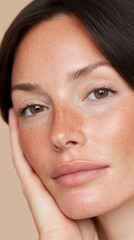 close up of a beautiful woman touching her face withher hand, with copy space.