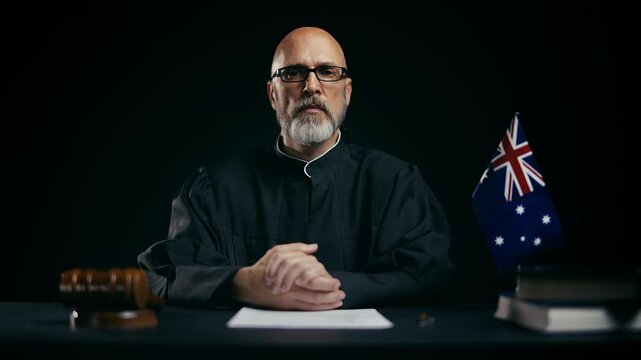 Portrait of middle-aged Australian judge looking at camera, legal authority