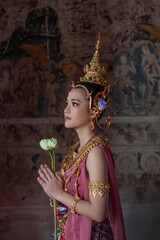Beautiful ASEAN woman in ancient Thai Dvaravati costume at an old temple in Chiang Mai, Thailand.