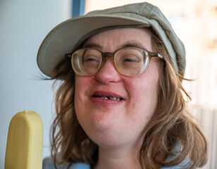 41 yo woman with the Down syndrome eating an ice cream, Tienen, Belgium