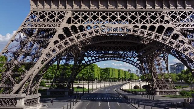 Eiffel Tower's Perspective: Captivating shot of the Eiffel Tower's intricate ironwork, offering a unique perspective of the iconic landmark framed against the backdrop of a clear, blue sky.