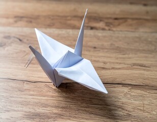 White Origami Crane on Wooden Surface
