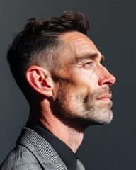 Obraz premium Stylish older man in sharp side profile light.