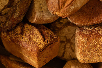 Close-up of various artisan breads, showcasing textures and colors. Perfect for bakery websites or food blogs.