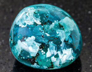 Closeup shot of a mesmerizing bluegreen gemstone with intricate, crystalline inclusions. Evokes beauty, tranquility, nature, and geological wonder. Ideal for spiritual themes.