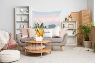 Interior of living room with sofa, LGBT and transgender flags