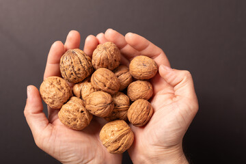 High-quality image of walnuts in hands. Perfect for healthy food blogs, websites, and packaging.