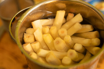 Close-up of freshly blanched bamboo shoots in a metal bowl, ready for cooking.