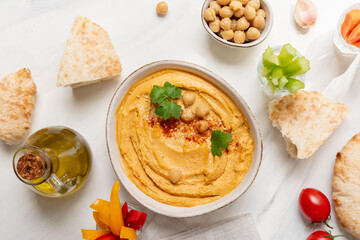 Fresh homemade hummus dipping sauce with vegetables and pita bread. vegan food healthy eating